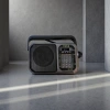 The black portable radio features an ultra-thin design, FM frequency modulation, digital display and is battery-powered details Picture